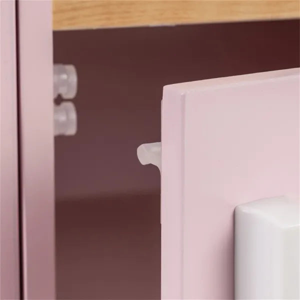 Close-up of a pink cabinet with a wooden top and white handle.