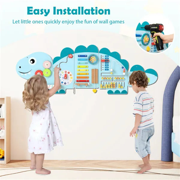 Children playing with a dinosaur-shaped wall game in a room.