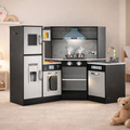 Children's play kitchen set with toy appliances in a room setting.