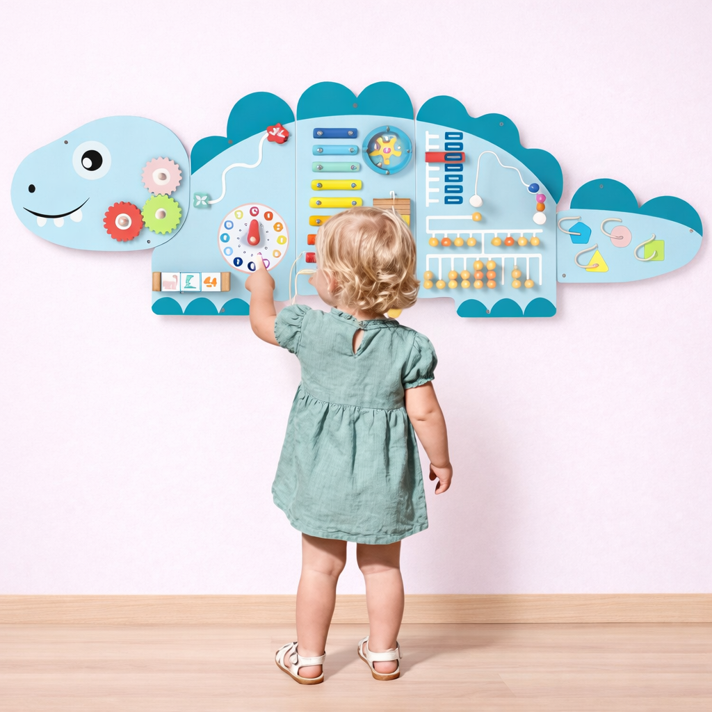 Child interacting with a dinosaur-shaped educational wall chart.