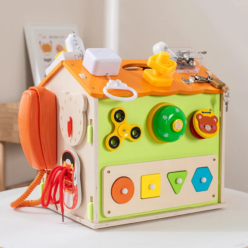 Colorful children's toy with various interactive elements on a white surface.