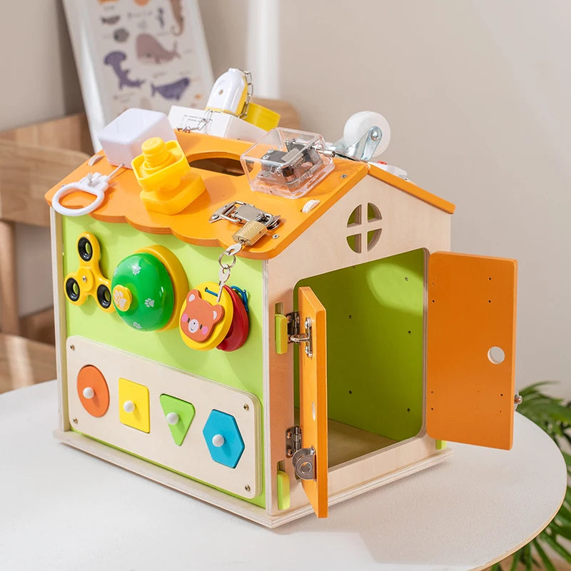 Colorful wooden toy with various interactive elements on a white surface.