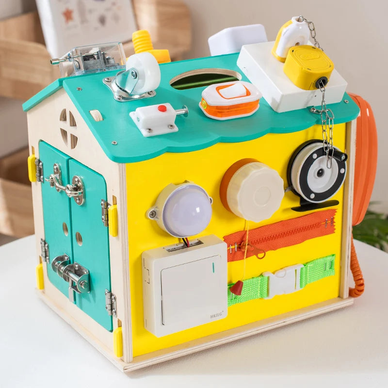 Colorful wooden activity cube with various mechanical components on a white surface.