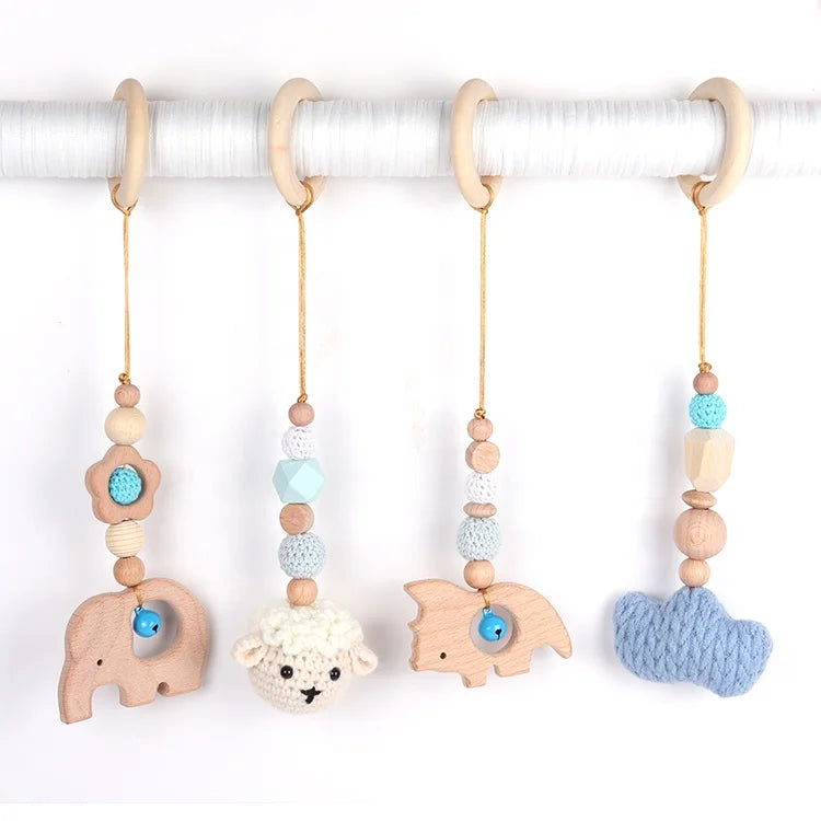 Set of four baby teething toys with animal shapes and beads on a white background