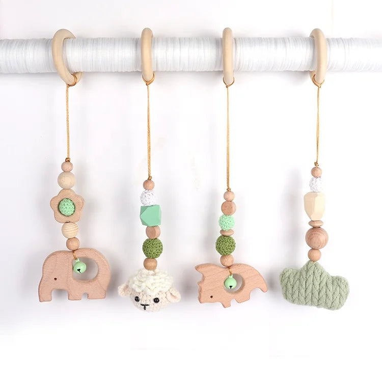Set of baby teething toys with wooden animals and beads on a white background