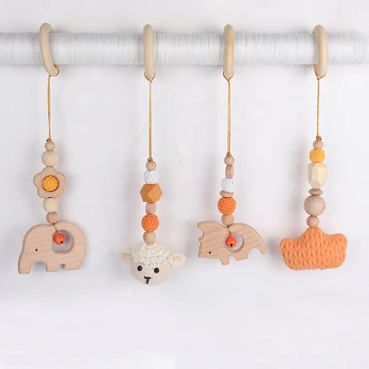 Set of baby toys with wooden animals and colorful beads on a white background