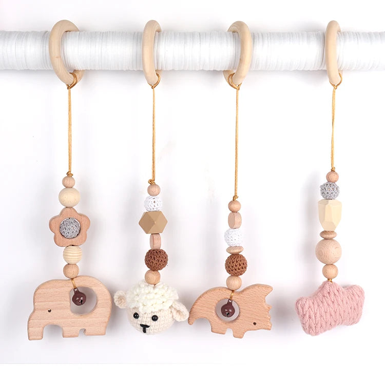 Set of baby teething toys with animal shapes and wooden beads on a white background