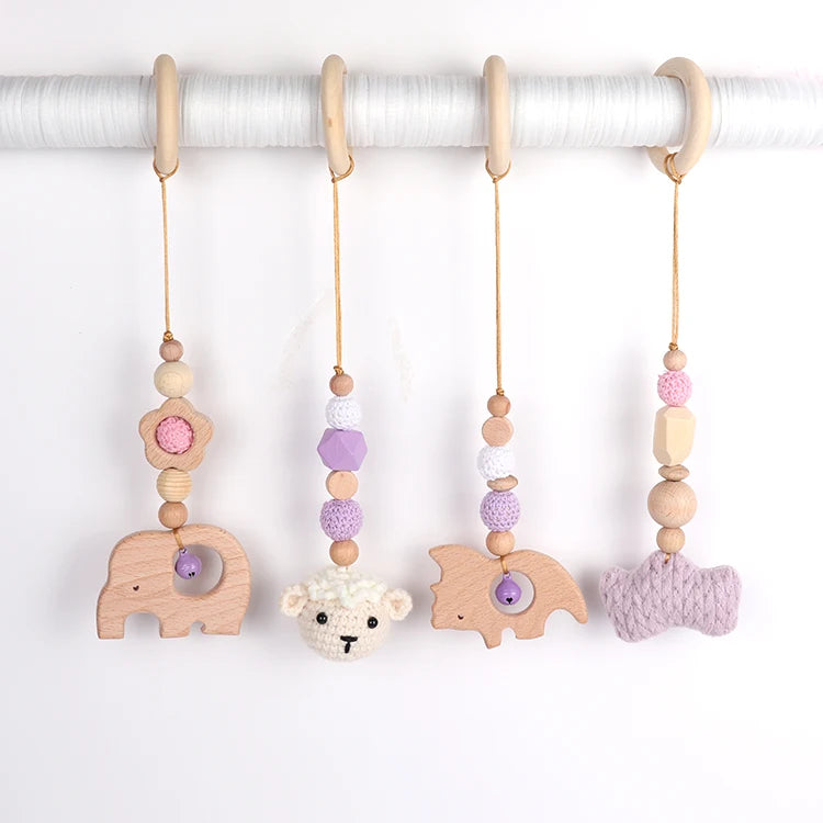 Set of baby teething toys with animal shapes and colorful beads on a white background
