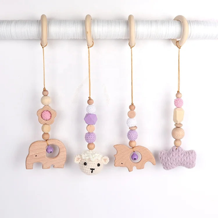 Set of baby teething toys with animal shapes and colorful beads on a white background
