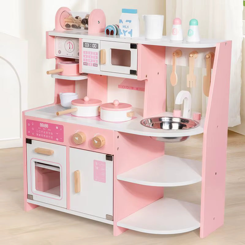 Pink children's play kitchen set with various accessories on a light wooden floor.