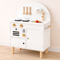 White toy kitchen set with wooden legs on a light wood floor.