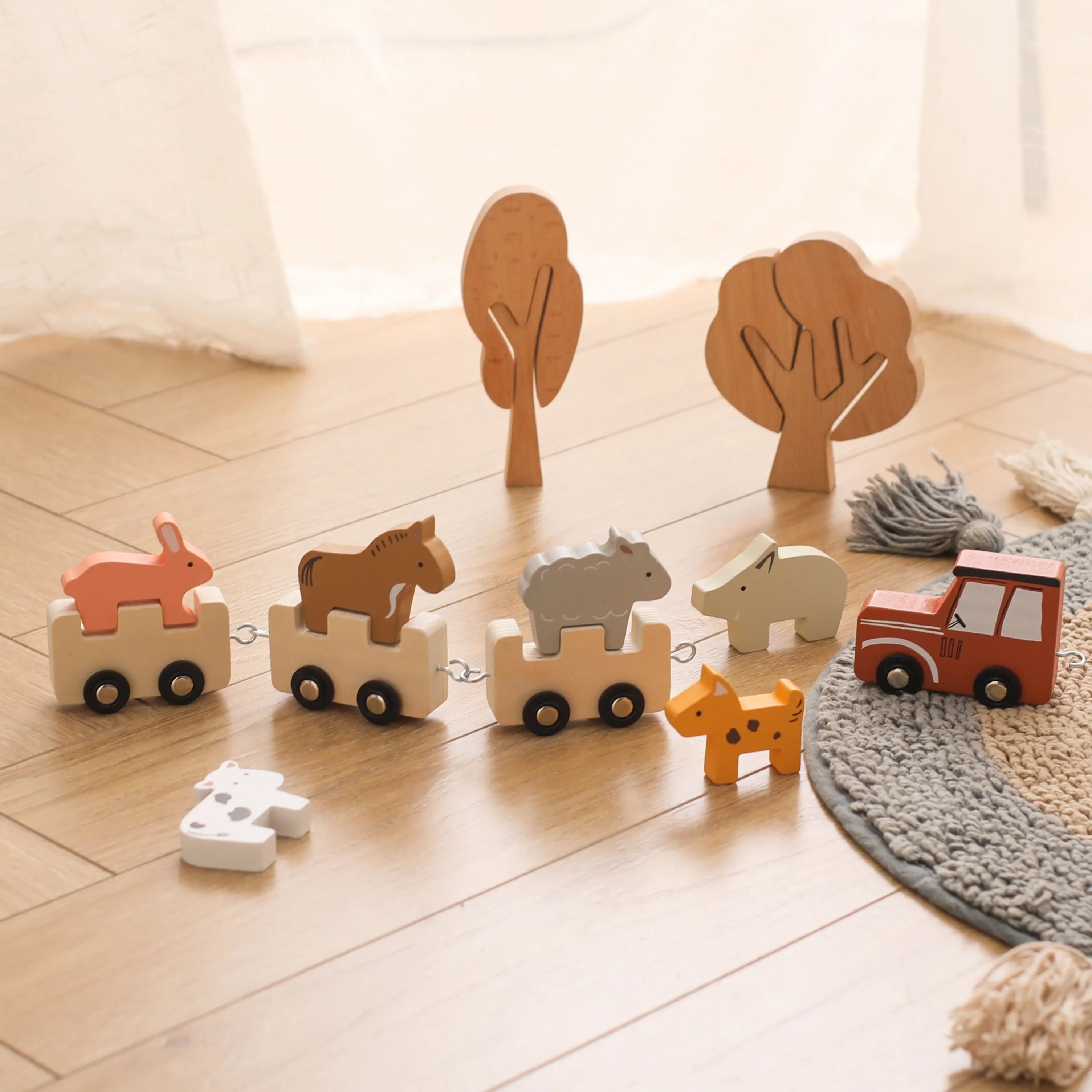 Set of wooden toys with animals and a car on a wooden floor.