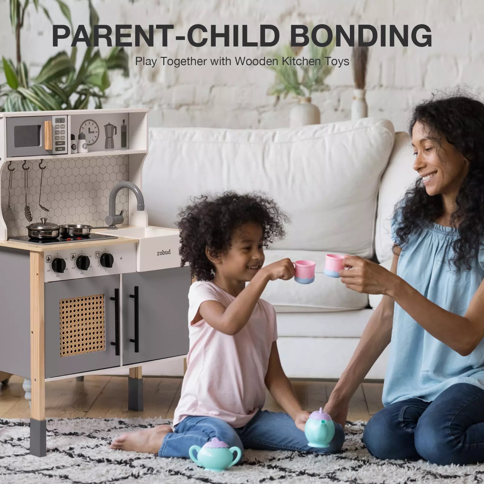 Woman and child playing with wooden kitchen toys in a living room setting.