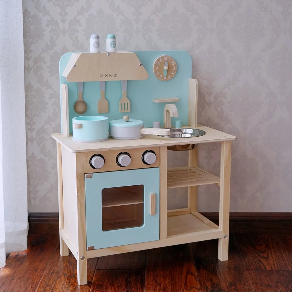 Children's wooden play kitchen set with blue and beige colors on a wooden floor.