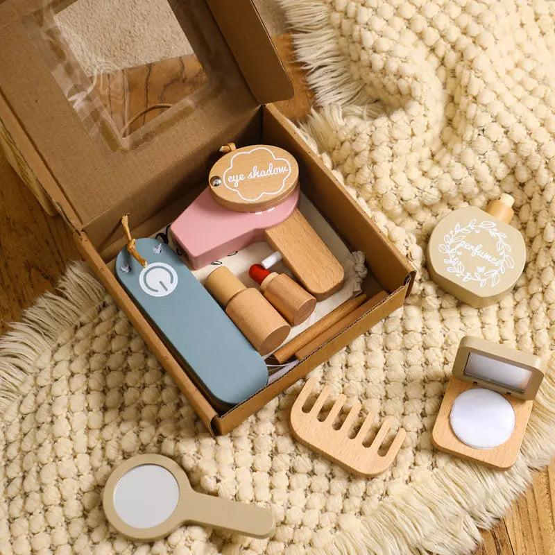 Set of wooden makeup tools including a mirror, brush, and other accessories on a textured surface.