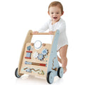 Child playing with a wooden toy walker on a white background