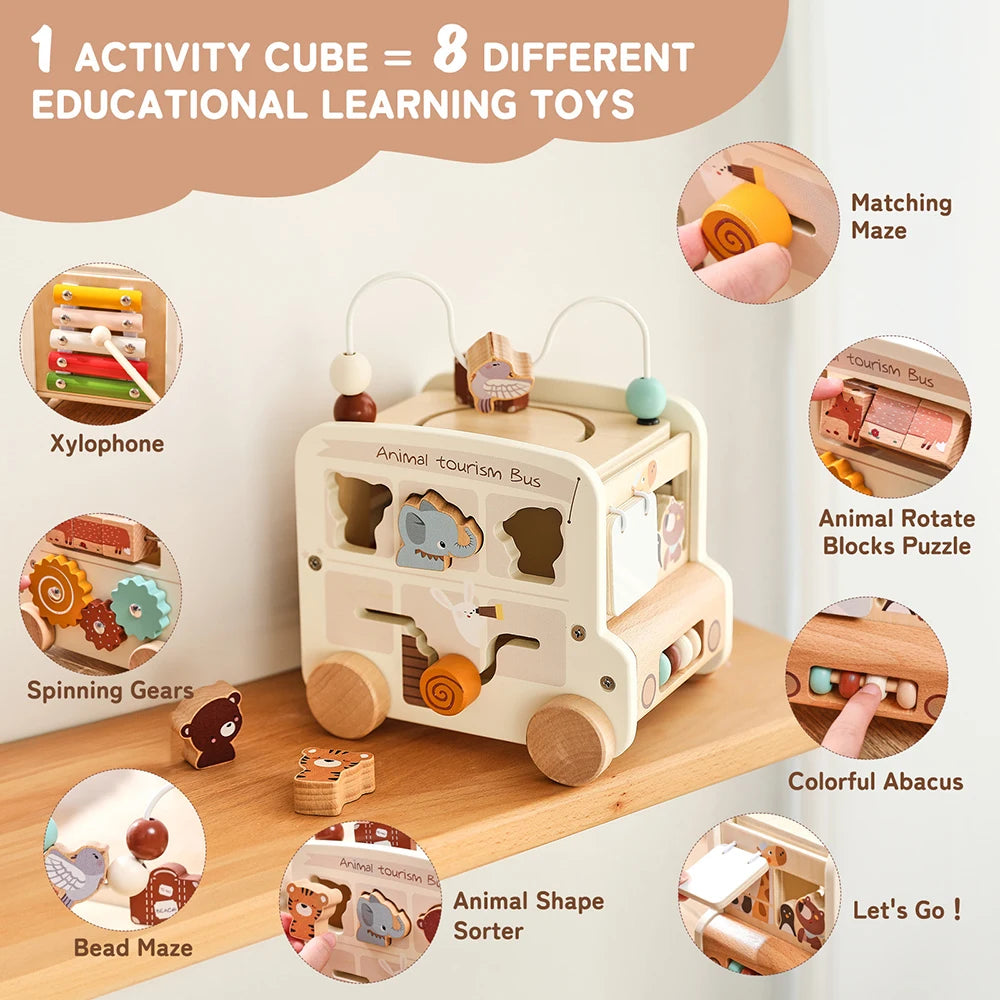 Wooden activity cube with educational toys and features on a wooden surface.